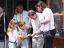 Mr & Mrs Cooper being presented with a button hole and flowers, click for a bigger picture.